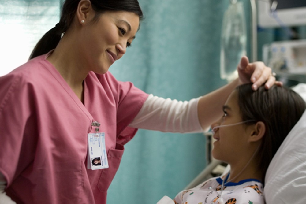 Nurse At Child's Bedside